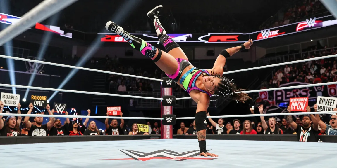 Roxanne Perez executing a dynamic wrestling move in the ring during an intense WWE match.